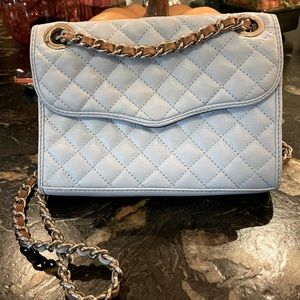 Rebecca Minkoff sky blue quilted purse w/ black & white animal print inside.